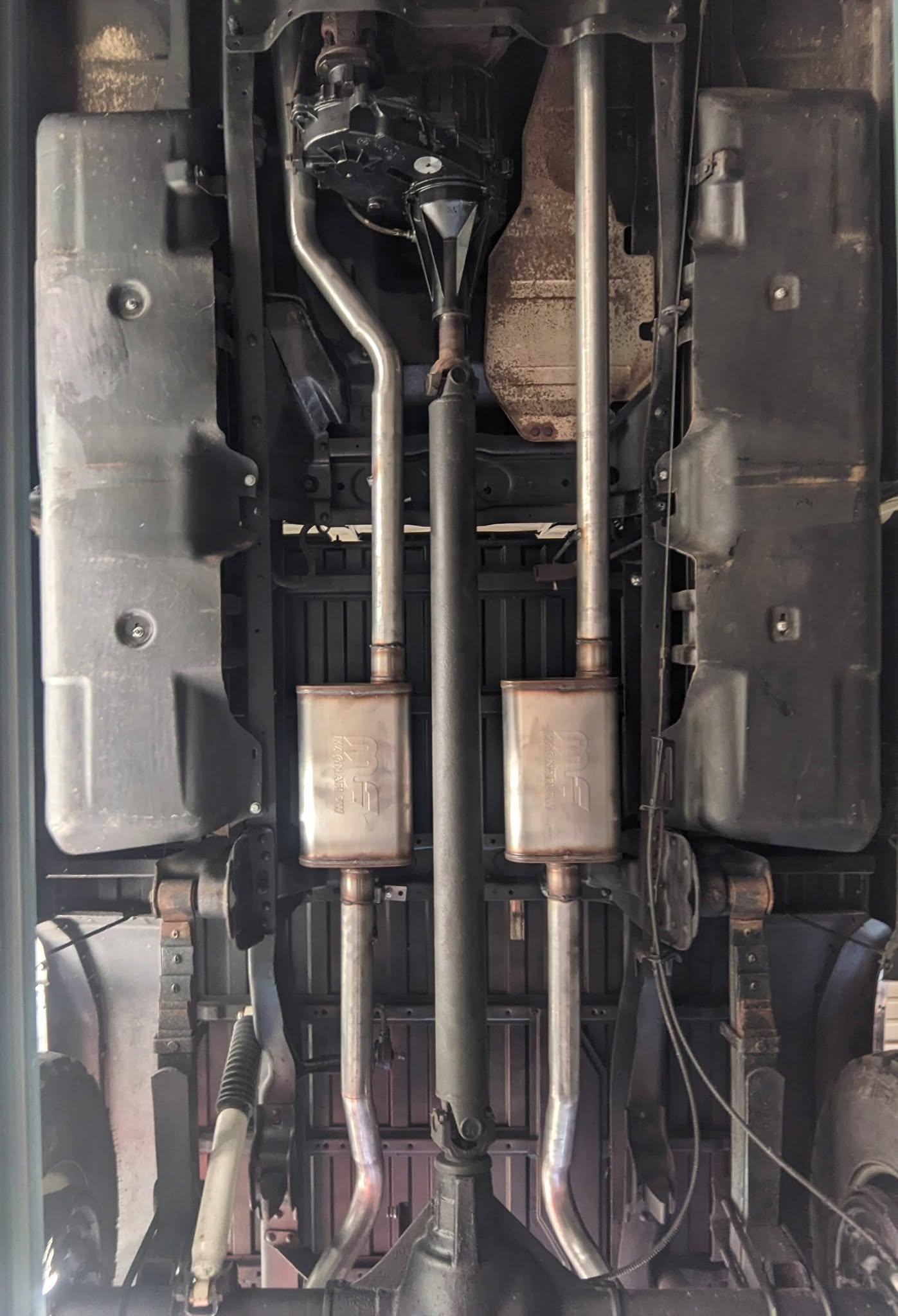 Dual exhaust pipes and mufflers close-up